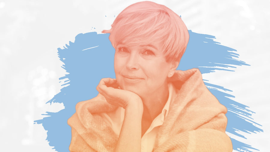 Woman with short blonde hair wrapped in a green blanket, for the BelleSkin article What to Look for in an Eye Cream for Wrinkles and Dark Circles