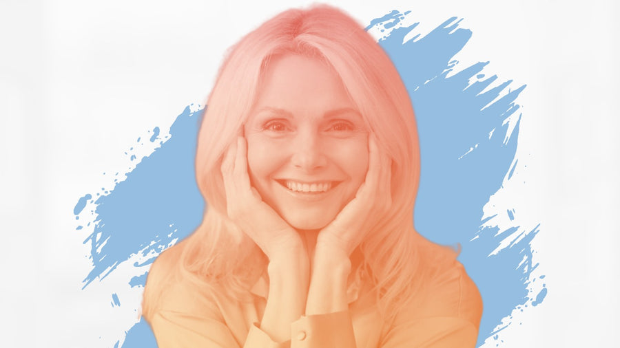 Smiling blonde woman resting her face in her hands, for the BelleSkin article Canadian Winter Skincare: 6 Changes to Make Before the Deep Freeze