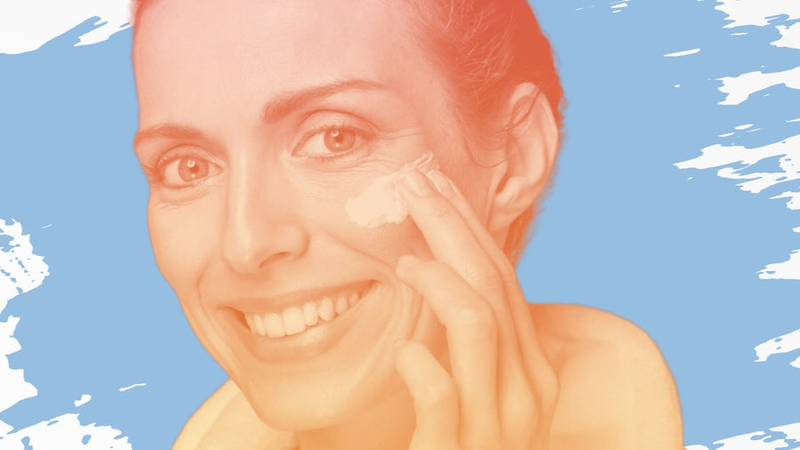 Smiling woman with dark hair applying face cream, for the BelleSkin article The Honest Truth About Glycolic Acid After 40
