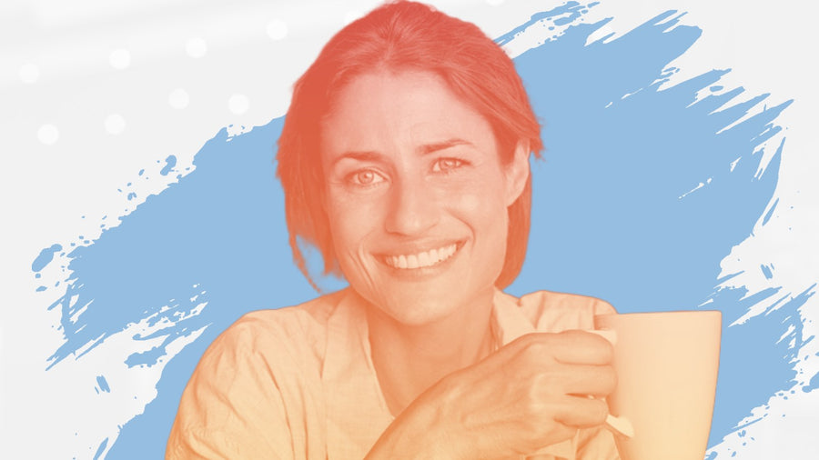 Smiling woman with dark hair holding a coffee mug, for the BelleSkin article How to Look Younger in Your 40s