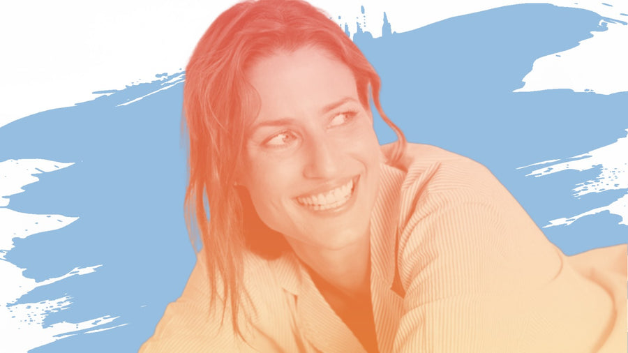 Smiling woman with brown hair leaning on her arms, for the BelleSkin article What Nobody Tells You About Salicylic Acid After 40